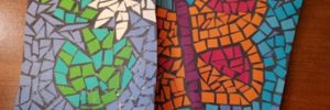 Colorful paper mosaics created at the Easter family workshop, showcasing vibrant patterns and designs.