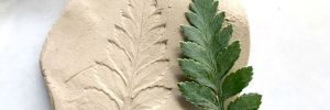 Spring nature workshop, medallion made from a plant imprint in clay