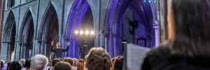 A view of a conductor, in the Nave of Saint Patrick's Cathedral, from the perspective of the choir.